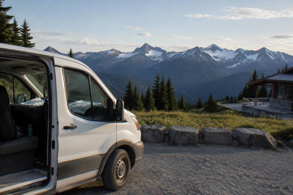 A tour van parked at a scenic overlook in the Olympic Mountains
